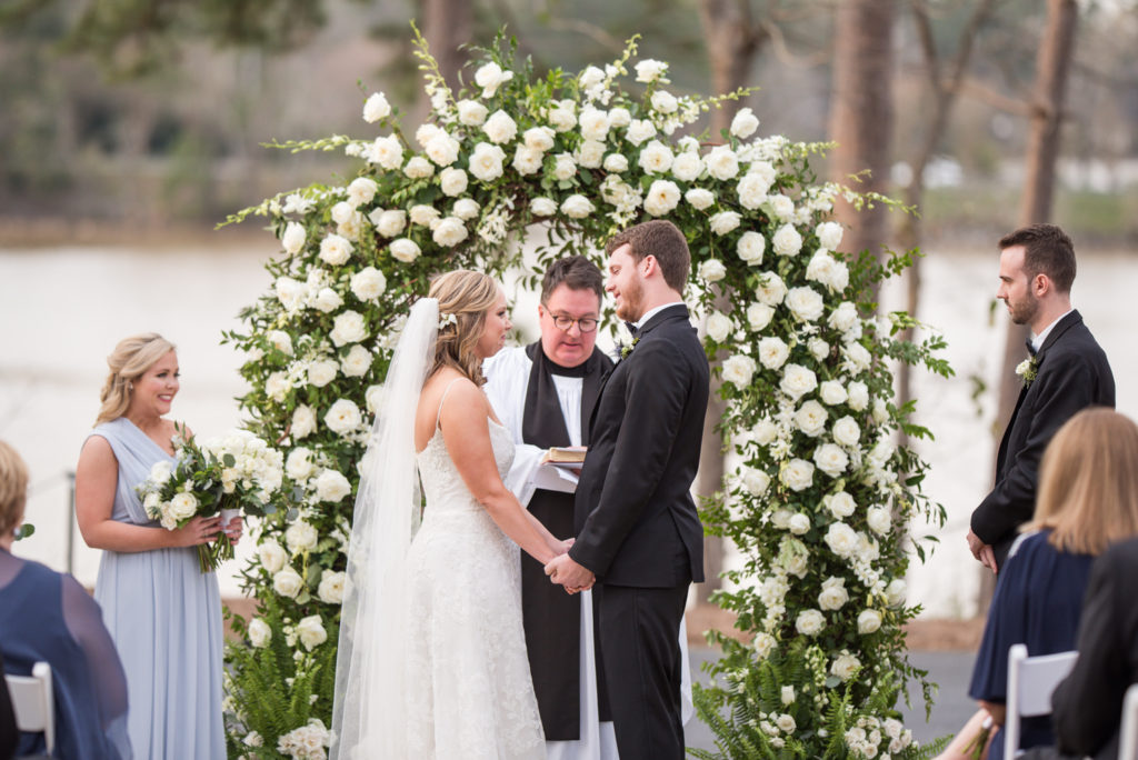 big eddy club wedding, bride and groom in front of floral arch