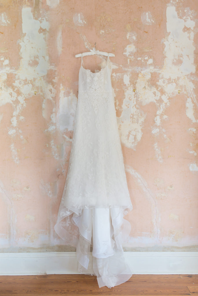 illges house wedding, lace wedding dress hanging on petina wall