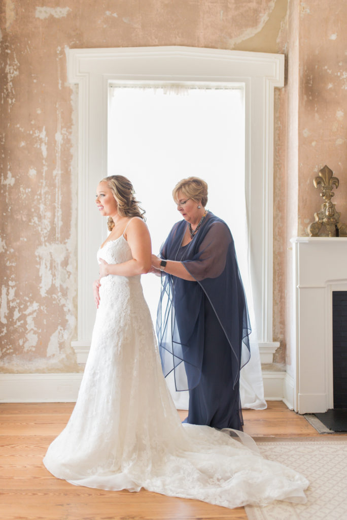 illges house wedding, mom helping bride into dress