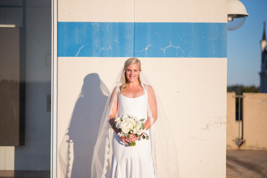 bride and groom on top of parking garage in columbus, ga at sunset by eliza morrill photography