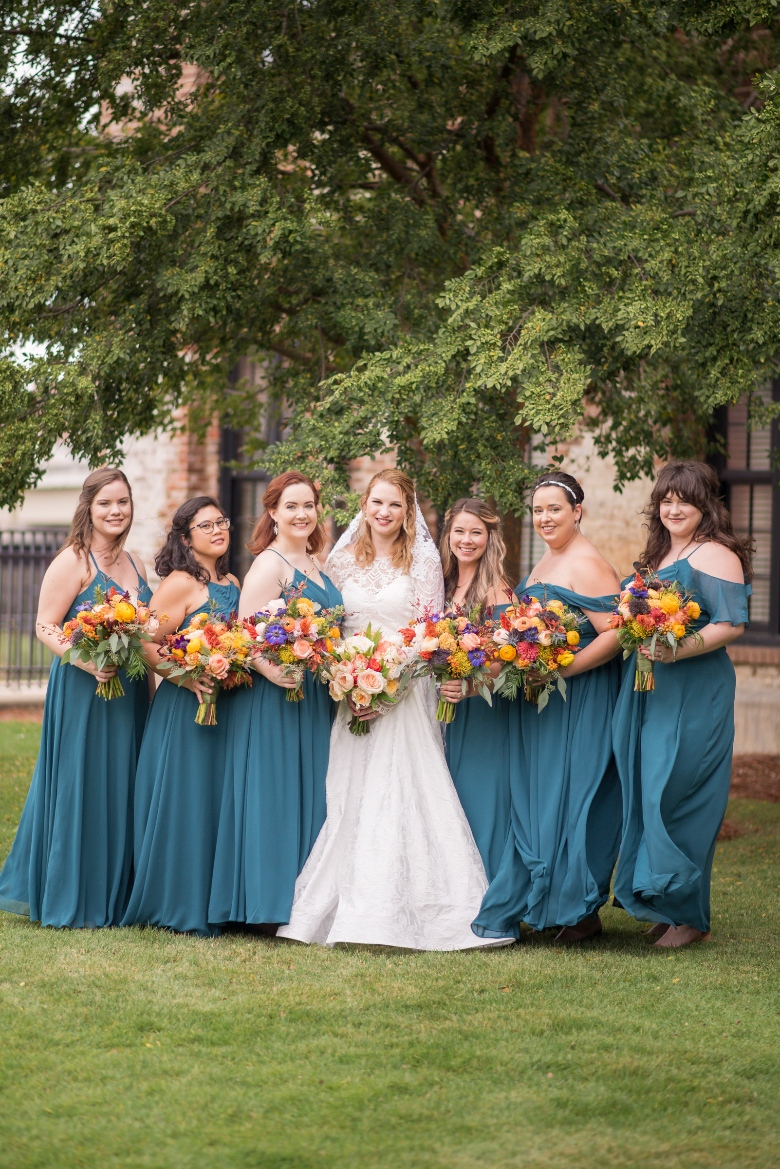 columbus, ga wedding at the powerhouses, bridesmaids with teal dresses and bright fall flowers