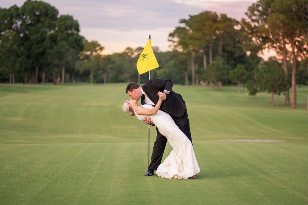 Ginny + Tripp's Country Club of Columbus, Ga Wedding, bride and groom dipping and kissing at sunset on a golf course
