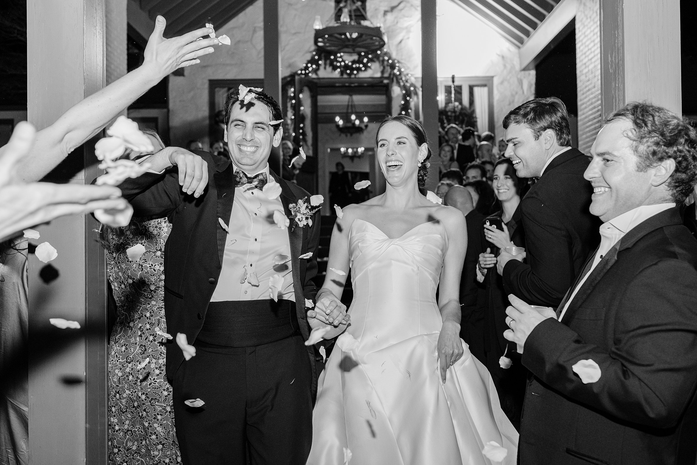 colorful winter wedding in columbus, ga - flower petal exit in black and white