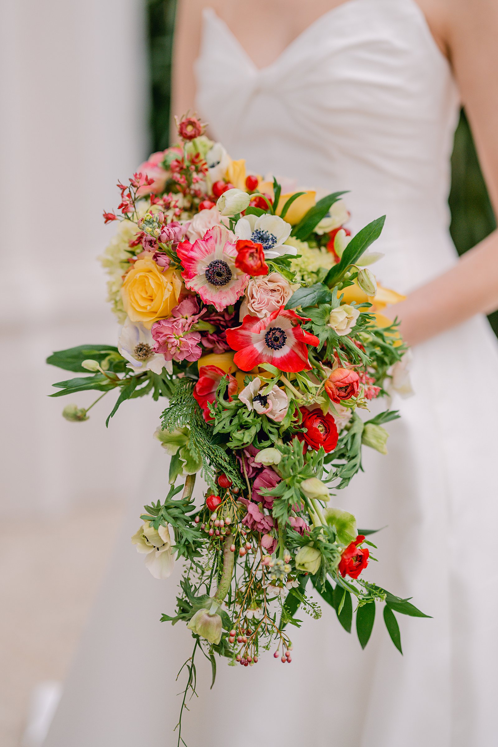 colorful winter wedding in columbus, ga  colorful winter bouquet with poppies, roses, and berries 