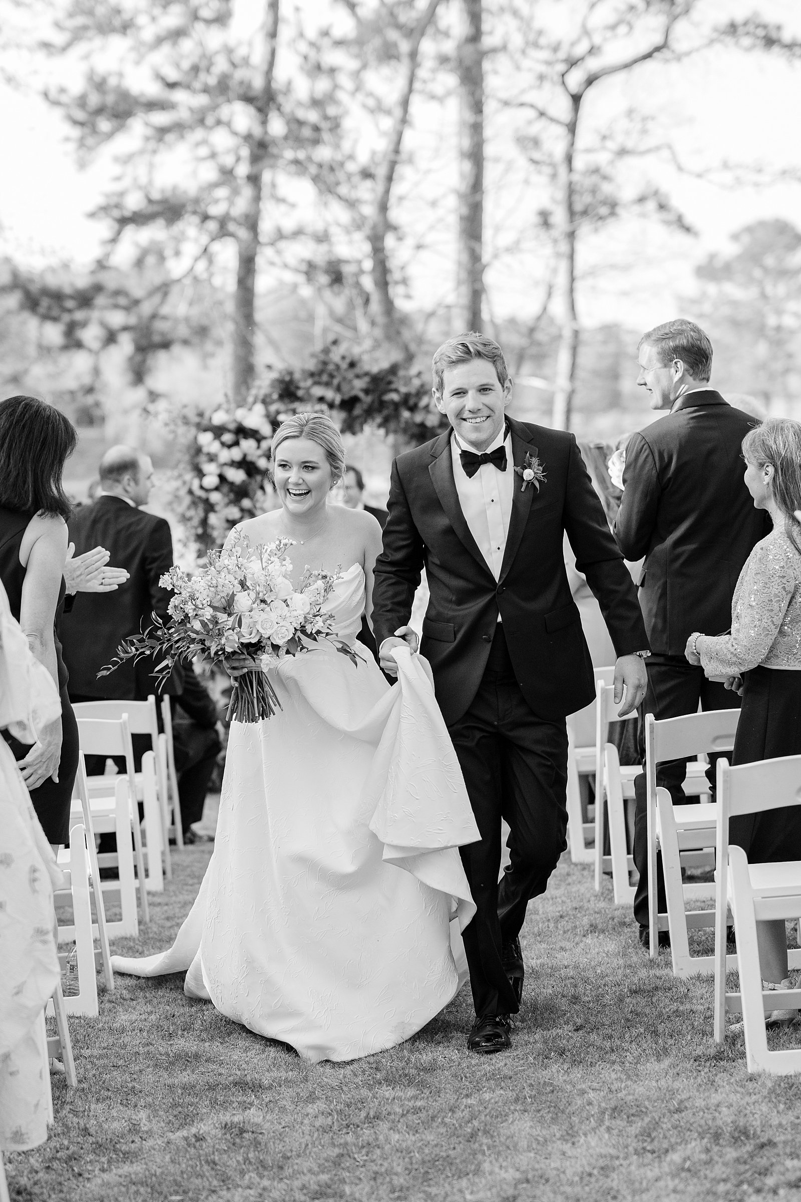 Outdoor Spring Wedding at the Big Eddy Club in Columbus, Ga walking back down the aisle in black and white 